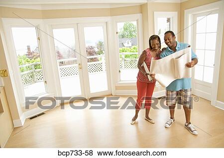 African couple looking at blueprints View Large Photo Image Stock Photo - African couple looking at blueprints. Fotosearch