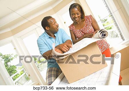African couple looking at blueprints View Large Photo Image Stock Photograph - African couple looking at blueprints. Fotosearch