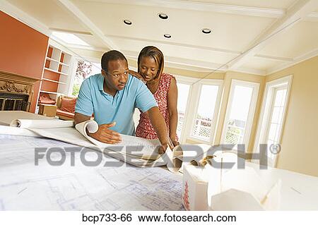 African couple looking at blueprints View Large Photo Image Stock Photograph - African couple looking at blueprints. Fotosearch