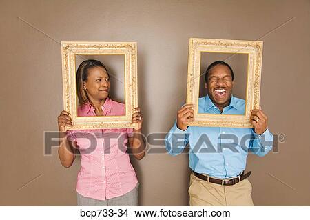 African couple looking through picture frames View Large Photo Image Picture - African couple looking through picture frames. Fotosearch