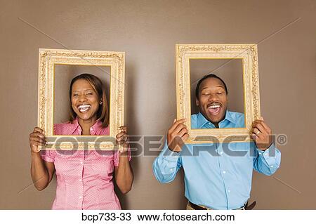 African couple looking through picture frames View Large Photo Image Stock Image - African couple looking through picture frames. Fotosearch