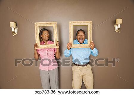 African couple looking through picture frames View Large Photo Image Stock Photograph - African couple looking through picture frames. Fotosearch