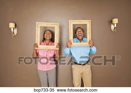 African couple looking through picture frames View Large Photo Image Stock Photography - African couple looking through picture frames. Fotosearch