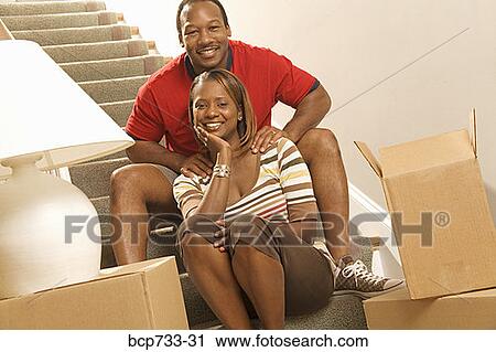 African couple next to moving boxes View Large Photo Image Stock Image - African couple next to moving boxes. Fotosearch
