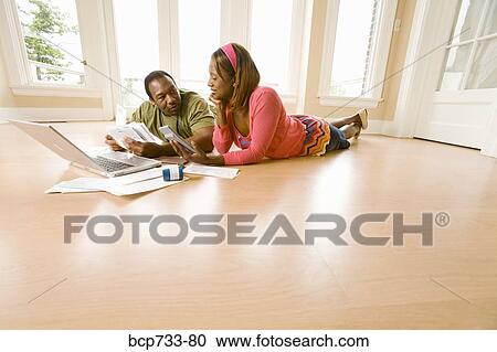 African couple paying bills in new house View Large Photo Image Stock Image - African couple paying bills in new house. Fotosearch