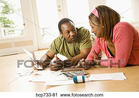 African couple paying bills in new house View Large Photo Image Stock Image - African couple paying bills in new house. Fotosearch