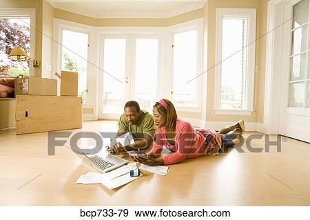 African couple paying bills in new house View Large Photo Image Stock Photo - African couple paying bills in new house. Fotosearch