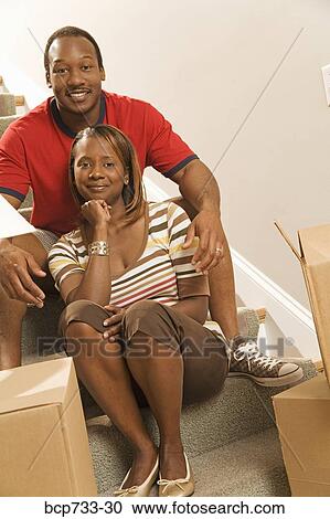 African couple sitting on stairs View Large Photo Image Stock Image - African couple sitting on stairs. Fotosearch