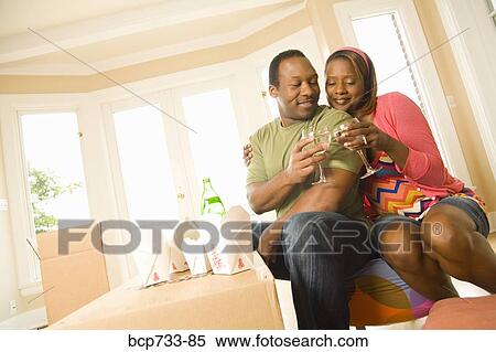 African couple toasting in new house View Large Photo Image Stock Photography - African couple toasting in new house. Fotosearch