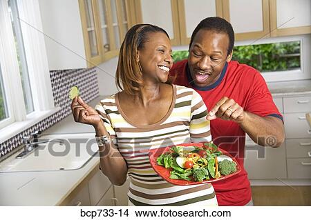 African couple with vegetable plate in kitchen View Large Photo Image Picture - African couple with vegetable plate in kitchen. Fotosearch