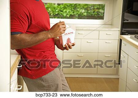 African man eating take out food View Large Photo Image Stock Image - African man eating take out food. Fotosearch