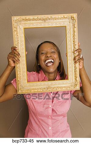 African woman looking through picture frame View Large Photo Image Stock Photography - African woman looking through picture frame. Fotosearch
