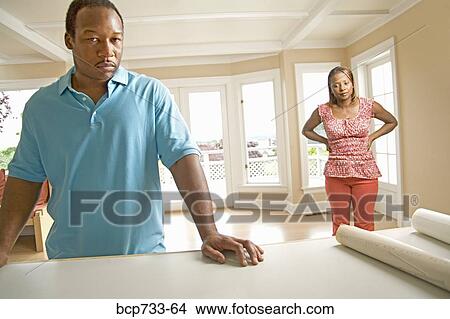 Picture - Angry African couple in new house. Fotosearch