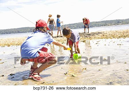 Asian sister and brother playing at beach View Large Photo Image Stock Photograph - Asian sister and brother playing at beach. Fotosearch