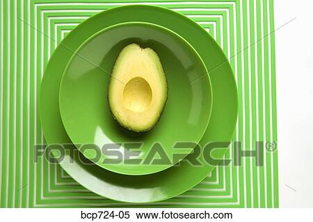 Avocado on green plate View Large Photo Image Stock Photography - Avocado on green plate. Fotosearch