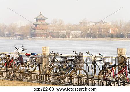 Bicycles parked by lake, Beijing, China View Large Photo Image Stock Photo - Bicycles parked by lake, Beijing, China. Fotosearch