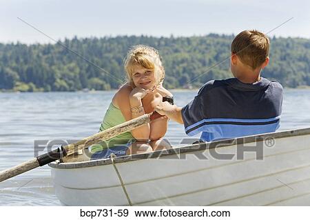 Stock Photo - Boy and girl in row boat. Fotosearch