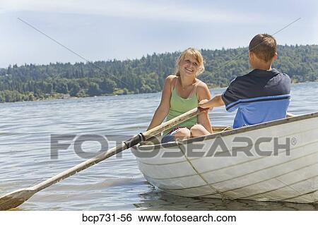 Stock Photograph - Boy and girl in row boat. Fotosearch
