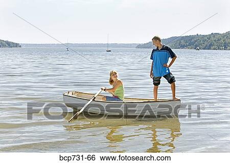 Stock Photograph - Boy and girl in row boat. Fotosearch