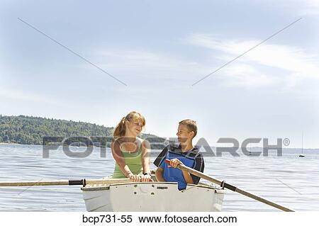 Boy and girl in row boat View Large Photo Image Stock Photography - Boy and girl in row boat. Fotosearch