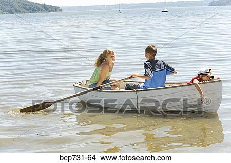 Boy and girl in row boat with young sibling View Large Photo Image Picture - Boy and girl in row boat with young sibling. Fotosearch