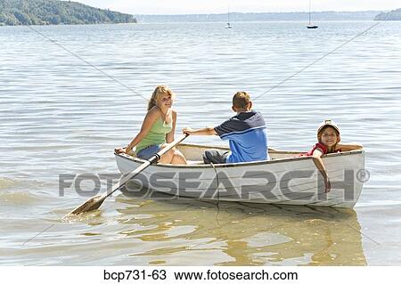 Boy and girl in row boat with young sibling View Large Photo Image Stock Image - Boy and girl in row boat with young sibling. Fotosearch