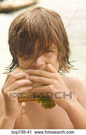 Boy eating sandwich View Large Photo Image Stock Image - Boy eating sandwich. Fotosearch
