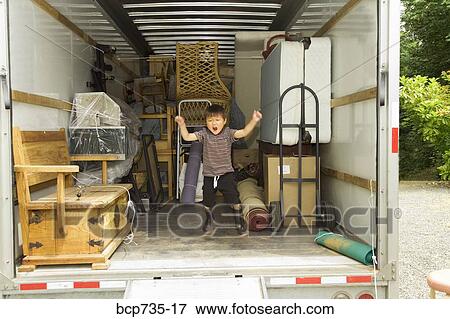 Stock Photo - Boy jumping in moving truck. Fotosearch