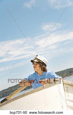 Boy wearing ship captain’s hat in row boat View Large Photo Image Stock Image - Boy wearing ship captain’s hat in row boat. Fotosearch