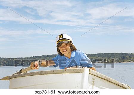 Boy wearing ship captain’s hat in row boat View Large Photo Image Stock Image - Boy wearing ship captain’s hat in row boat. Fotosearch