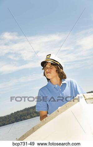 Boy wearing ship captain’s hat View Large Photo Image Stock Photo - Boy wearing ship captain’s hat. Fotosearch