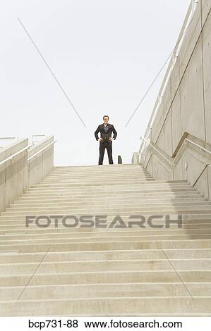 Stock Photo - Businessman at top of steps. Fotosearch
