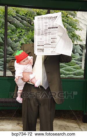 Businessman holding baby at bus stop View Large Photo Image Stock Image - Businessman holding baby at bus stop. Fotosearch