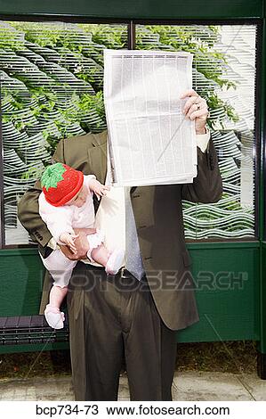Businessman holding baby at bus stop View Large Photo Image Stock Image - Businessman holding baby at bus stop. Fotosearch