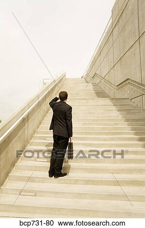 Businessman looking up steps View Large Photo Image Stock Image - Businessman looking up steps. Fotosearch