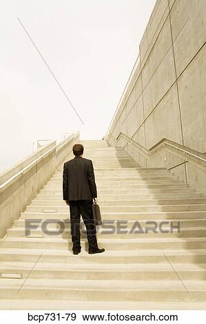 Businessman looking up steps View Large Photo Image Stock Photo - Businessman looking up steps. Fotosearch
