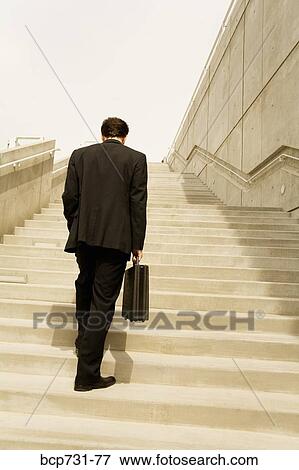 Businessman walking up steps View Large Photo Image Stock Photo - Businessman walking up steps. Fotosearch