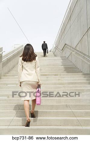 Businesspeople walking up steps View Large Photo Image Stock Photograph - Businesspeople walking up steps. Fotosearch