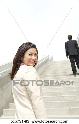 Businesswoman looking over shoulder View Large Photo Image Stock Image - Businesswoman looking over shoulder. Fotosearch