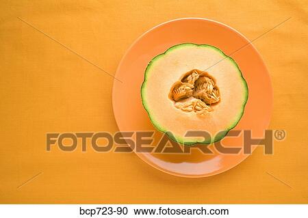 Cantaloupe on orange plate View Large Photo Image Stock Image - Cantaloupe on orange plate. Fotosearch