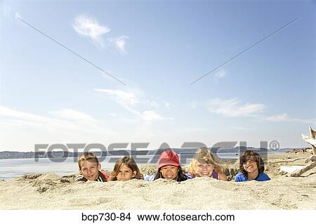 Children in sand at beach View Large Photo Image Picture - Children in sand at beach. Fotosearch
