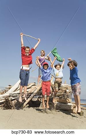 Children jumping next to beach fort View Large Photo Image Stock Image - Children jumping next to beach fort. Fotosearch