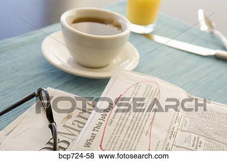 Circled classified ad next to coffee cup View Large Photo Image Stock Photo - Circled classified ad next to coffee cup. Fotosearch