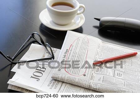 Stock Image - Circled classified ad next to coffee cup and telephone. Fotosearch