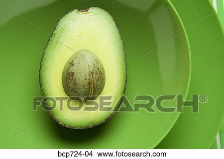Close up of avocado on green plate View Large Photo Image Picture - Close up of avocado on green plate. Fotosearch