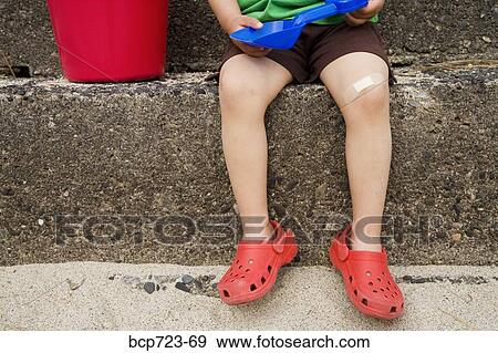 Close up of young boy sitting on steps View Large Photo Image Stock Photo - Close up of young boy sitting on steps. Fotosearch