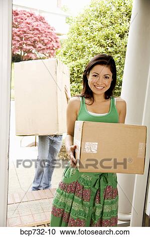Couple carrying moving boxes View Large Photo Image Stock Image - Couple carrying moving boxes. Fotosearch