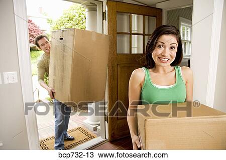 Couple carrying moving boxes View Large Photo Image Stock Image - Couple carrying moving boxes. Fotosearch