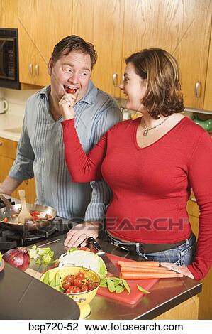Couple cooking together View Large Photo Image Stock Image - Couple cooking together. Fotosearch