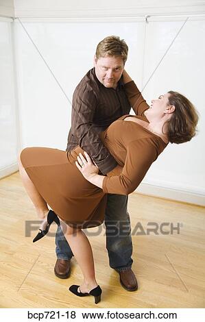 Couple dancing in living room View Large Photo Image Stock Photo - Couple dancing in living room. Fotosearch